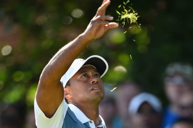 Tiger Woods tests the wind at the fifth hole during yesterdays first round at Hoylake. Picture: Getty