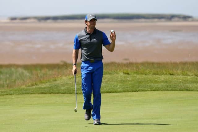 Rory McIlroy acknowledges the crowd as he strides off the 13th green at Royal Liverpool yesterday. Picture: AP