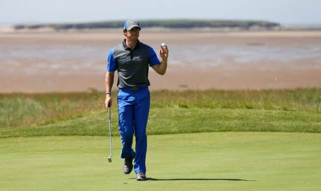 Rory McIlroy acknowledges the crowd as he strides off the 13th green at Royal Liverpool yesterday. Picture: AP