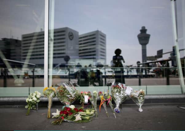 Floral tributes Schiphol Airport's entrance in memory of the victims of flight MH17. Picture: Getty