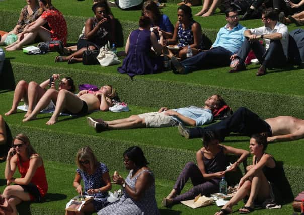 People relax as temperatures soar to their highest of the year. Picture: Getty