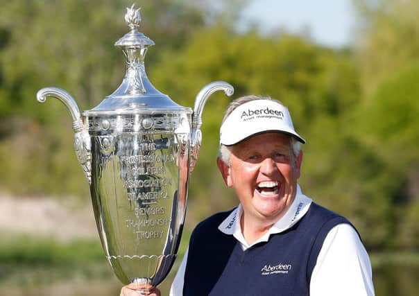 Colin Montgomerie lifts the Alfred S Bourne Trophy after winning his first 'major', the 2014 Senior PGA Championship at Benton Harbour, Michigan, in May. Picture: Getty