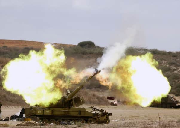 An Israeli tank  fires a shell into Gaza. Picture: Getty