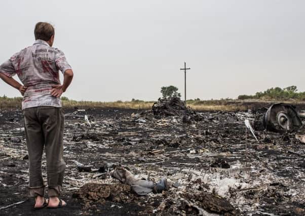 A man looks at debris from an Air Malaysia plane crash. Picture: Getty