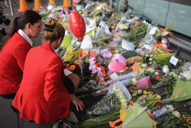 Cabin crew lay flowers at the entrance to Schiphol Airport in memory of the victims of Malaysia Airlines flight MH17. Picture: Getty