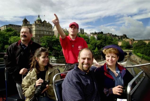 A tour guide in Edinburgh. The report on productivity criticises jobs in tourism. Picture: Pamela Grigg