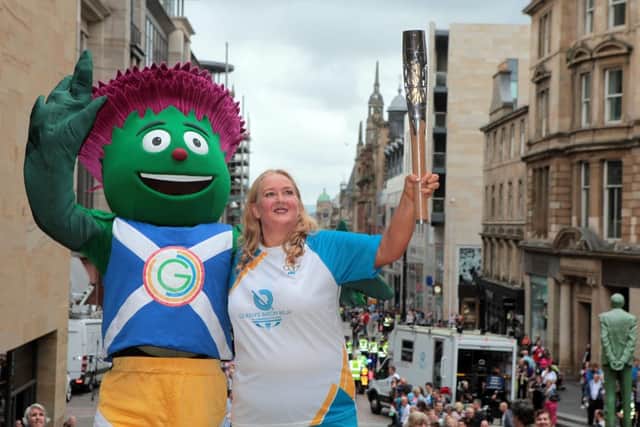 Jackie Smith with Clyde and the baton at the top of Buchanan Street. Picture: HEMEDIA