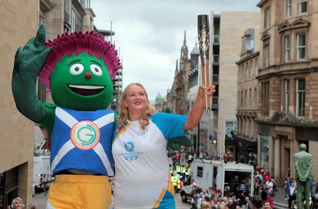 Jackie Smith with Clyde and the baton at the top of Buchanan Street. Picture: HEMEDIA