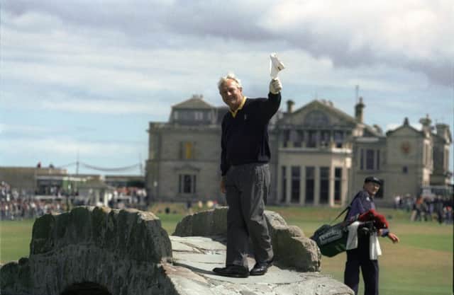Two-time Open champion Arnold Palmer waves goodbye to fans from the Swilken Bridge on the Old Course at St Andrews in 1995. Picture: Getty