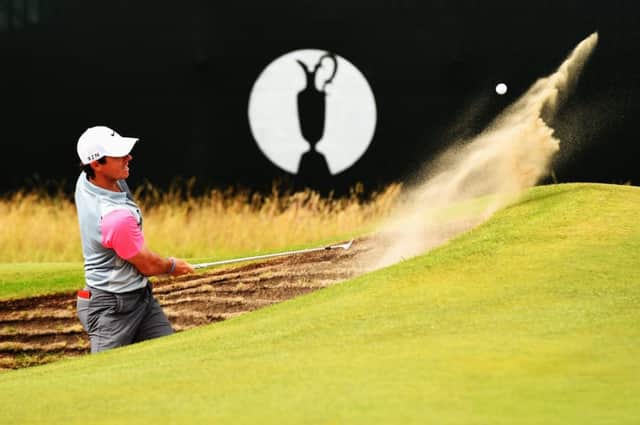 Rory McIlroy fires out of a greenside bunker at the seventh. Picture: Getty
