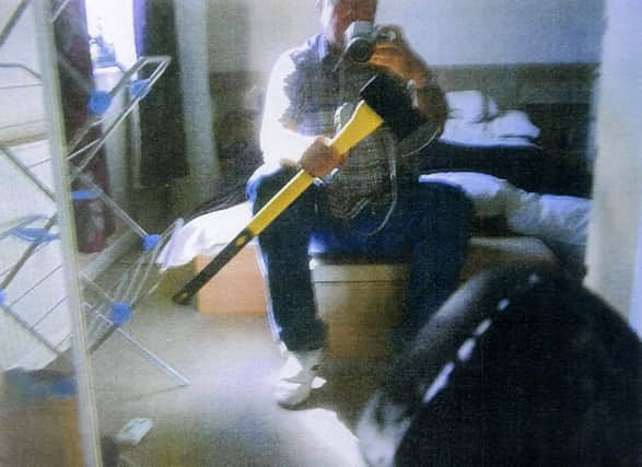 Dale Bolingers selfie photo shows the axe he bought at Homebase. Picture: SWNS