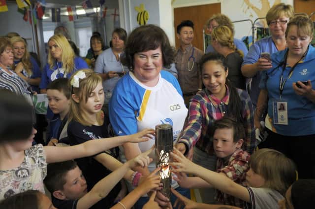 Young patients at Glasgows Yorkhill hospital gather round Susan Boyle during her visit to their ward. Picture: Getty