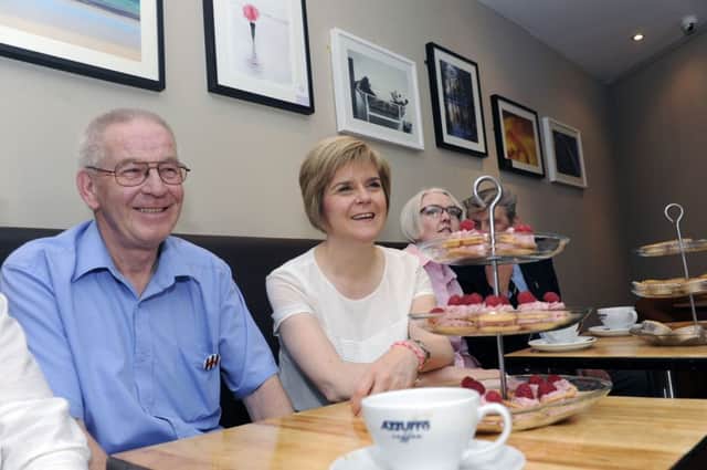 Nicola Sturgeon enjoys a joke with undecided business owners in Paisley yesterday. Picture: John Devlin