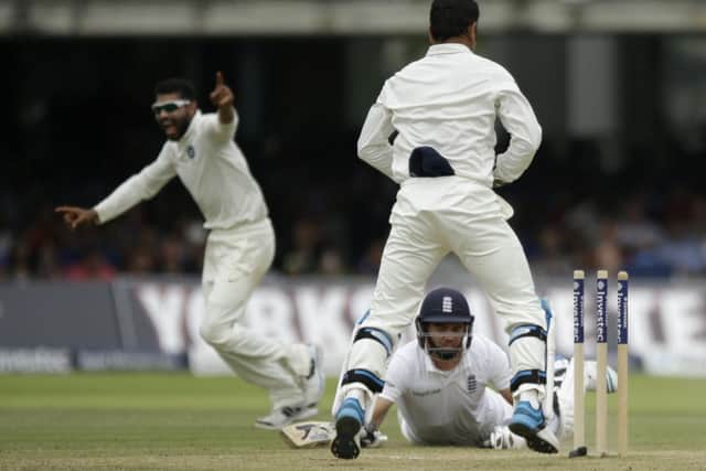 Indias Ravindra Jadeja, left, celebrates after running out Englands James Anderson. Picture: AP