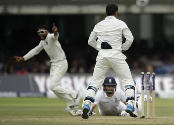 Indias Ravindra Jadeja, left, celebrates after running out Englands James Anderson. Picture: AP