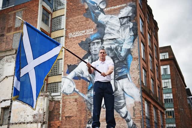 Euan Burton poses with the Saltire in Glasgow yesterday. Picture: Getty
