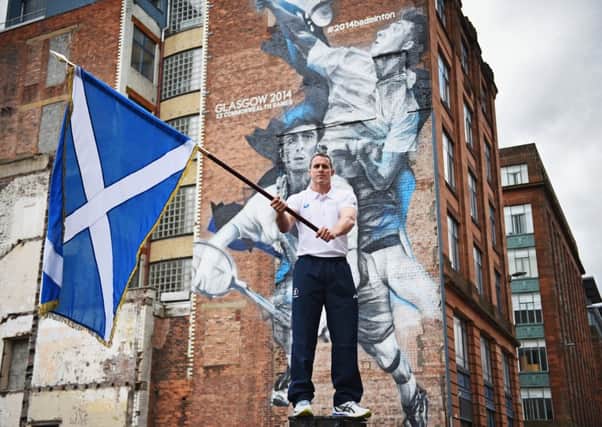 Euan Burton poses with the Saltire in Glasgow yesterday. Picture: Getty