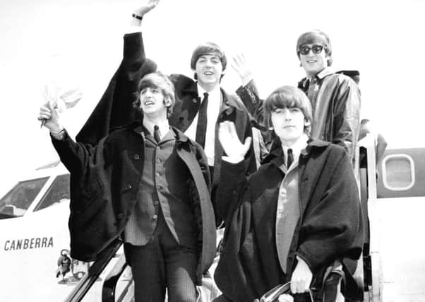 George Harrison, bottom right, with fellow Beatles Ringo Starr, Paul McCartney and John Lennon. Picture: Getty