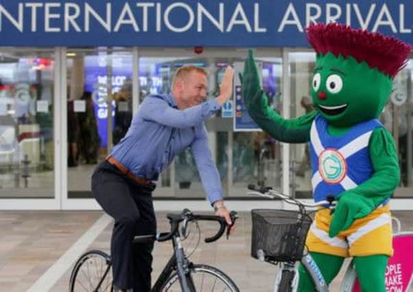 Sir Chris Hoy with Commonwealth Games 2014 mascot Clyde at Glasgow Airport. Picture: Hemedia