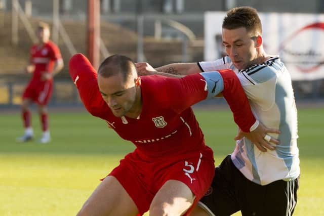 Dundee captain James McPake holds off Hearts striker James Keatings at Dens Park. Picture: SNS