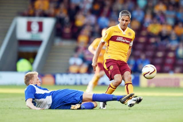 Keith Lasley is challenged by Martin Rauschenberg. Motherwell let slip a two-goal lead in the first leg. Picture: SNS