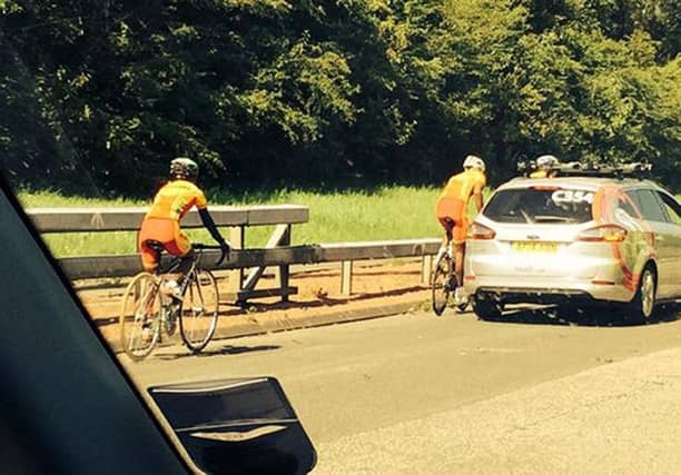 Two Sri Lankan athletes as they cycle down the M74 motorway. Picture: Jonny Brownlee/PA