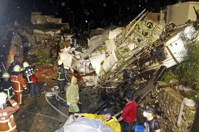 Rescuers at the site of the crash near Xixi village on Penghu island. Picture: AP
