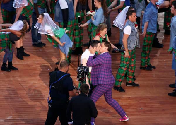 John Barrowman kisses the male bride during the Opening Ceremony for the Glasgow 2014 Commonwealth Games. Picture: Getty