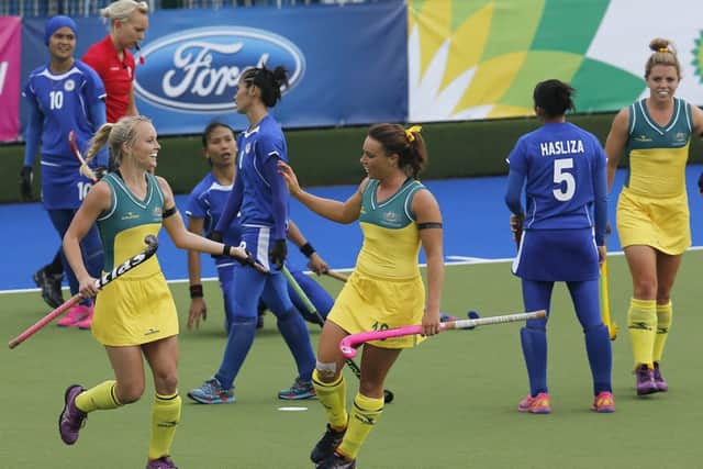 Australia's Georgina Parker, center, celebrates after scoring during the hockey match between Australia and Malaysia. picture: AP