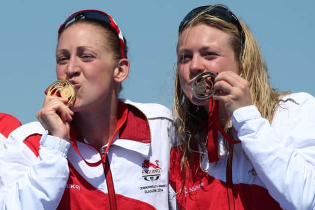 Englands Jodie Stimpson (left) with her gold medal after winning the Womens Triathlon alongside teammate Vicky Holland. Picture Getty