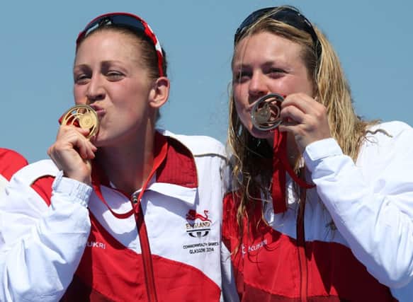 Englands Jodie Stimpson (left) with her gold medal after winning the Womens Triathlon alongside teammate Vicky Holland. Picture Getty