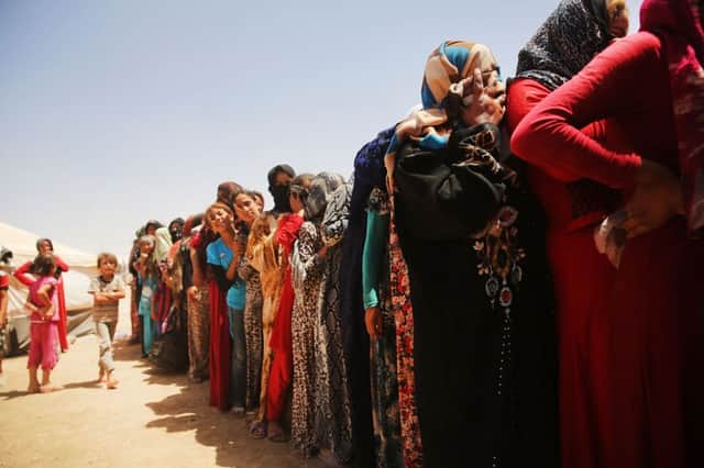 Women and girls queue for aid at a refugee camp near Irbil providing sanctuary for people fleeing occupied Mosul. Picture: Getty