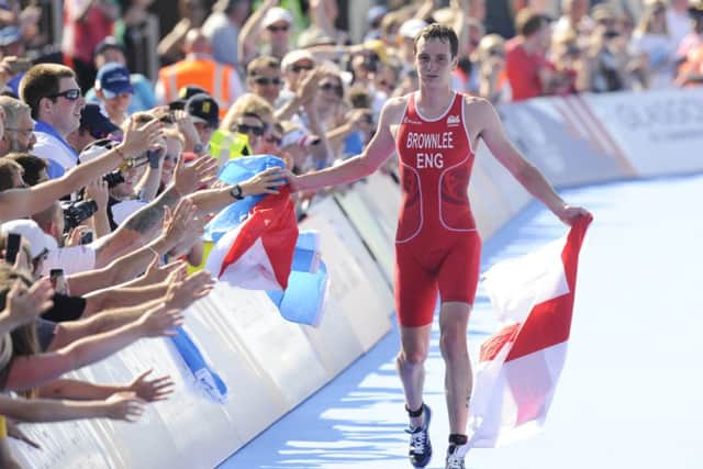 Alistair Brownlee celebrates his gold medal with the crowd. Picture: Greg Macvean