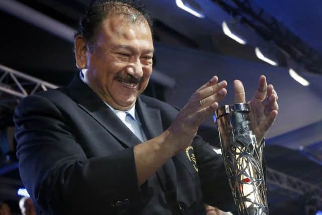 Prince Imran tries to open the Queen's Baton, and struggles. Picture: Getty