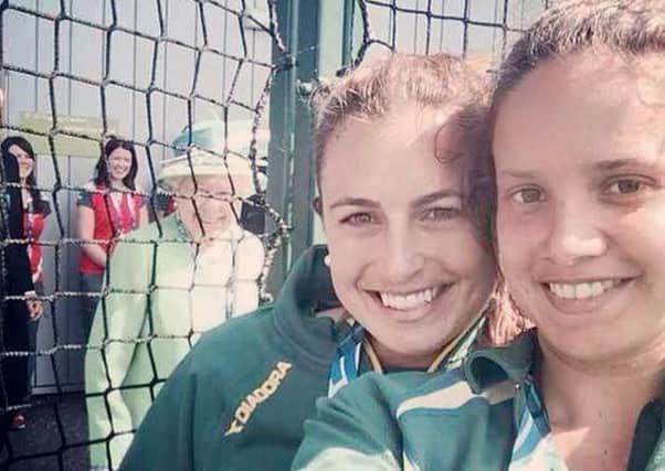 The Queen photobombs Jayde Taylor and her team-mate Brooke Peris. Picture: SWNS