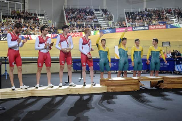 Sir Bradley Wiggins, Steven Burke, Andy Tennannt and Ed Clancey, and the Australian team on the podiums. Picture: PA