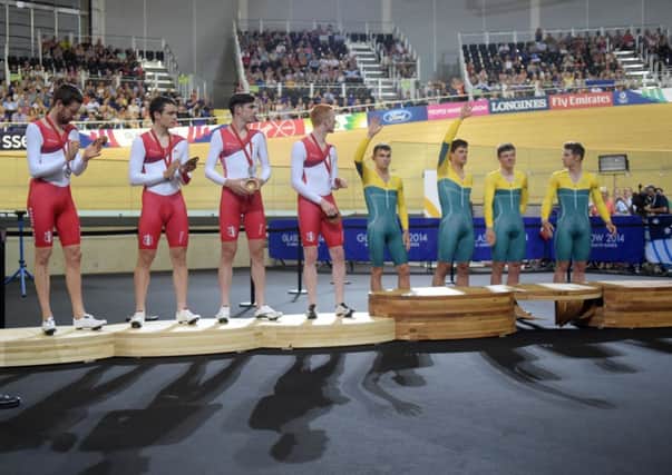 Sir Bradley Wiggins, Steven Burke, Andy Tennannt and Ed Clancey, and the Australian team on the podiums. Picture: PA