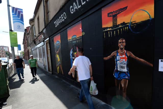 A wall mural displaying Mo Farahs image in Parkhead was as close as the Englishman got to Glasgow 2014. Picture: PA