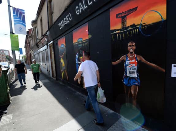 A wall mural displaying Mo Farahs image in Parkhead was as close as the Englishman got to Glasgow 2014. Picture: PA