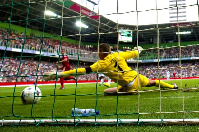 Niall McGinn (left) fires the ball by FC Groningen keeper Sergio Padt. Picture: SNS