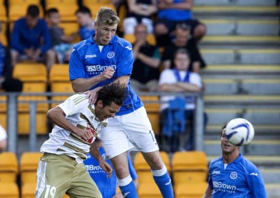 St Johnstones David Wotherspoon rises above Adrian Winter of Luzern to win a header. Picture: SNS