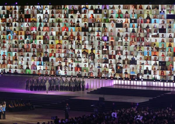 A video wall of faces on screen are displayed during a UNICEF appeal at the opening ceremony for the Commonwealth Games. Picture: AP