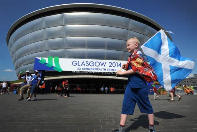 Scotland fan Callum Hodgon, 7, outside the SSE Hydro at Glasgow, which has enjoyed blue skies and hot weather all week. Picture: Jane Barlow