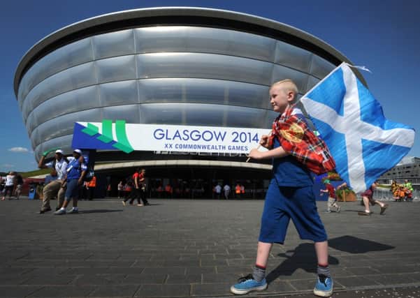 Scotland fan Callum Hodgon, 7, outside the SSE Hydro at Glasgow, which has enjoyed blue skies and hot weather all week. Picture: Jane Barlow