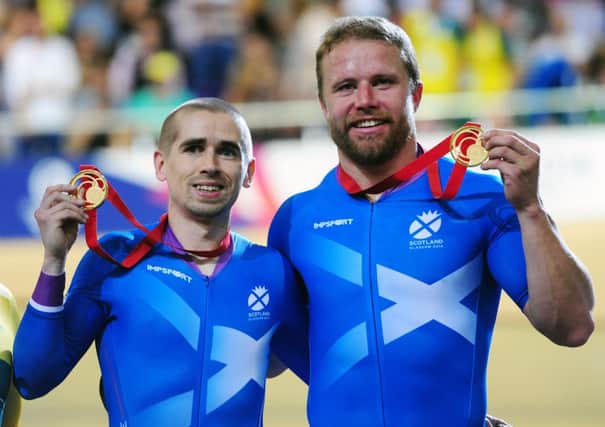 Neil Fachie and Craig MacLean show off their gold medals in the Sir Chris Hoy Velodrome. Picture: Ian Rutherford