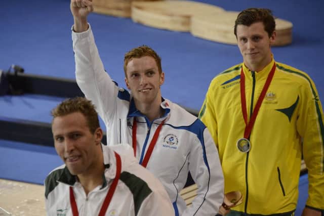 Dan Wallace salutes the crowd after receiving his gold medal following his dramatic victory in the mens 400m individual medley final. Picture: Andrew OBrien