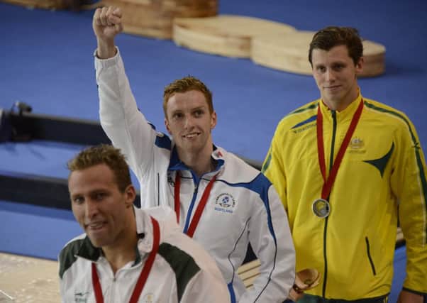 Dan Wallace salutes the crowd after receiving his gold medal following his dramatic victory in the mens 400m individual medley final. Picture: Andrew OBrien