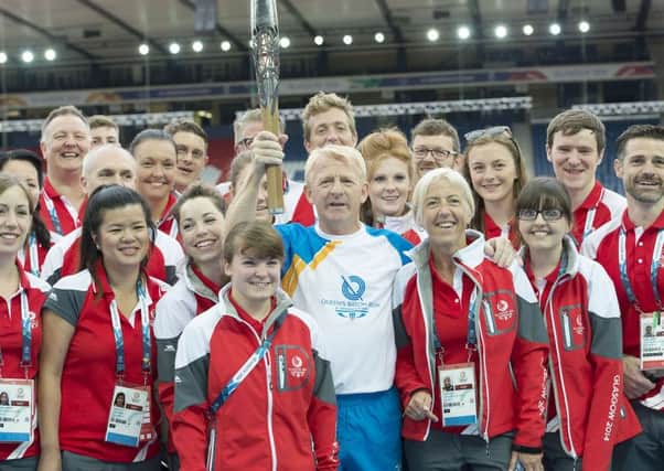 Scotland manager Gordon Strachan (centre) parades the Queen's Baton with Commonwealth Volunteers in Hampden. Picture: SNS