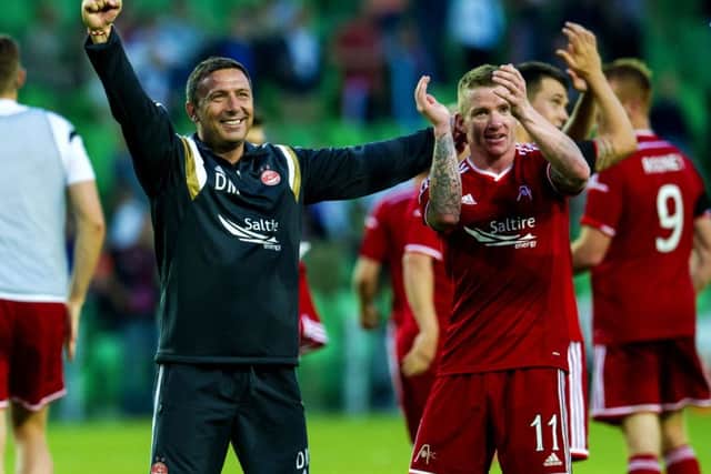 Aberdeen manager Derek McInnes celebrates with star man Jonny Hayes after Gronigen win. Picture: SNS