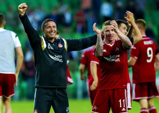 Aberdeen manager Derek McInnes celebrates with star man Jonny Hayes after Gronigen win. Picture: SNS